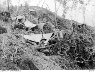 Upper Ramu Valley, New Guinea. October 1943. This Australian post, on the edge of a 3000 ft precipice, was under Japanese artillery fire when this photograph was taken