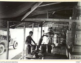 TOROKINA, BOUGAINVILLE ISLAND. 1945-01-30. PERSONNEL OF THE DETAILS ISSUING DEPOT, 4TH SUPPLY DEPOT PLATOON BREAKING UP SUPPLIES INTO SMALL QUANTITIES FOR ISSUE TO SOME OF THE SMALLER AUSTRALIAN ..