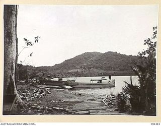 NANTAMBU, NEW BRITAIN. 1945-07-26. THE BEACH HEAD WITH BARGES FROM A DETACHMENT, 53 PORT CRAFT COMPANY IN THE FOREGROUND