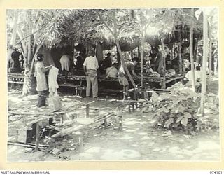 DUGUMUR BAY, NEW GUINEA. 1944-06-16. THE NATIVE QUARTERS USED BY THE JAPANESE TO HOUSE SOME OF THE 90 CHINESE WHICH THEY CAPTURED AT MADANG. THESE CHINESE WERE USED BY THE JAPANESE TO WORK A LARGE ..