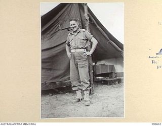 BUT, NEW GUINEA. 1945-04-10. MAJ C.L. SIMPSON, ADMINISTRATIVE COMMANDER, 2/8 INFANTRY BATTALION, OUTSIDE HIS TENT