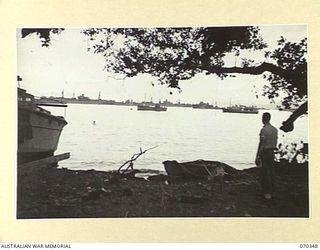 MILNE BAY, NEW GUINEA. 1944-02-09. A SECTION OF THE WATERFRONT AT MILNE BAY VIEWED EASTWARD FROM THE HEAD OF THE BAY NEAR THE SITE OF THE OLD LADAVA MISSION WHICH IS NOW THE NAVAL HEADQUARTERS, AND ..