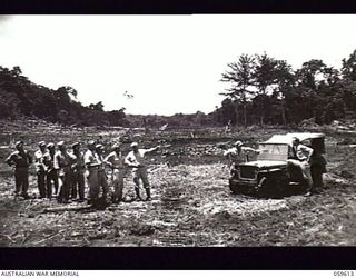 DREGER HARBOUR, NEW GUINEA. 1943-11-02. MEMBERS OF THE 808TH UNITED STATES ENGINEER AVIATION BATTALION ON THE NEW AIRSTRIP WHICH THEY ARE CONSTRUCTING. LEFT TO RIGHT: T/4 GEORGE F. DECKER (2); ..