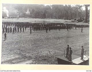 TOROKINA, BOUGAINVILLE. 1945-05-18. TROOPS OF 7 INFANTRY BRIGADE ON PARADE AT GLOUCESTER PARK DURING AN ADDRESS BY LIEUTENANT GENERAL S.G. SAVIGE, GENERAL OFFICER COMMANDING 2 CORPS (2). PERSONNEL ..