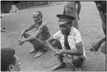 Yeria, Wanuma Census Division: man in police-style cap, man in wide bark belt