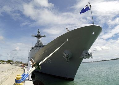 Republic of Korea Navy (ROKN) Sailors place a "rat guard" on the bow mooring line of the ROKS CHUNGMUGONG YI SUN SHIN (DDH 975) as they complete mooring and arrival operations in Apra Harbor, Guam