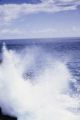 Oceania, waves crashing along shoreline of island in South Pacific