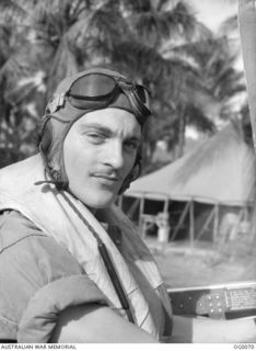 MILNE BAY, PAPUA. 1943-07-15. INFORMAL PORTRAIT OF SQUADRON LEADER (LATER WING COMMANDER) GEOFFREY C. ATHERTON OF LAUNCESTON, TAS, WEARING HIS HEAD GEAR AND MAE WEST LIFEJACKET, COMMANDING NO. 75 ..