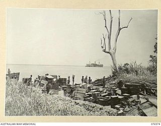 HOSKINS, NEW BRITAIN. 1944-10-09. ONE OF THE MANY BEACHHEADS ESTABLISHED BY THE 36TH INFANTRY BATTALION. NOTE THE DUTCH TROOPSHIP "SWARTENHONDT" IN THE BACK-GROUND