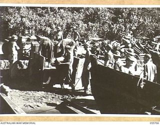 NASSAU BAY, NEW GUINEA. 1943-08-16. TROOPS OF "D" COMPANY, 542ND ENGINEER BOAT AND SHORE REGIMENT UNITED STATES FORCES, LOADING BARGES. SHOWN ARE:- 39179438 CLARENCE H. PETERSON (1); 33320596 ..