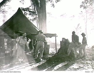 THE SOLOMON ISLANDS, 1945-05. AUSTRALIAN ARMY OFFICERS AT THEIR CAMP SITE AT NORTH BOUGAINVILLE. (RNZAF OFFICIAL PHOTOGRAPH.)