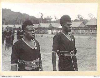 TOROKINA, BOUGAINVILLE, 1945-08-04. TWO MEMBERS OF THE ROYAL PAPUAN CONSTABULARY WHO WERE PRESENTED WITH VALOUR MEDALS BY LIEUTENANT-GENERAL S.G. SAVIGE FOR BRAVERY IN THE FACE OF HEAVY JAPANESE ..