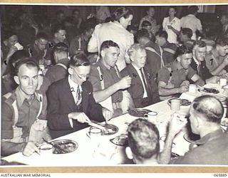 HERBERTON, QLD. 1944-04-25. EX-SERVICEMEN OF FIRST WORLD WAR AND PERSONNEL OF HEADQUARTERS, 6TH DIVISION BEING ENTERTAINED AT A DINNER IN THE LOCAL SHIRE HALL AT THE CONCLUSION OF THE ANZAC DAY ..