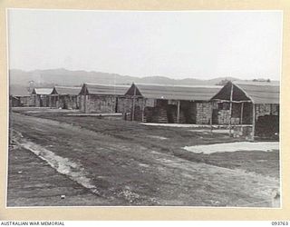 CAPE WOM, WEWAK AREA, NEW GUINEA, 1945-07-02. STORE SHEDS IN USE AT 2/22 SUPPLY DEPOT PLATOON. THERE ARE 6 SHEDS MEASURING 20 BY 100 FEET; 2 SHEDS MEASURING 20 BY 220 FEET, AND ONE SHED MEASURING ..