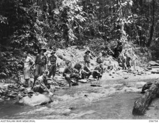 SALAMAUA AREA, NEW GUINEA. 1943-07-22. TROOPS OF "A" COMPANY, 2/5TH BATTALION, RESTING AT A MOUNTAIN STREAM AFTER COMING OUT OF THE FRONT LINE AT MOUNT TAMBU. LEFT TO RIGHT: VX27238 PRIVATE (PTE) ..