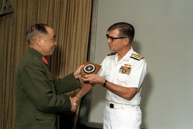 Mr. Xu Yimin, Defense and Military Attache, People's Republic of China, left, presents VADM Edward S. Briggs, deputy and chief of staff, with a plaque during a briefing at Pacific Fleet headquarters