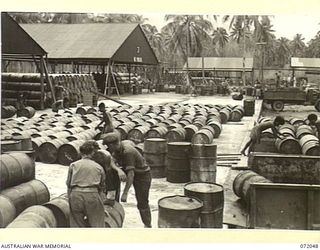 MILNE BAY, NEW GUINEA. 1944-04-04. A REFILLING SHED WITH THE LOADING PLATFORM FOR 44 GALLON DRUMS SHOWN IN THE MIDFORGROUND AT THE 2ND AUSTRALIAN BULK PETROLEUM STORAGE COMPANY TERMINAL