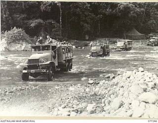 BOUGAINVILLE ISLAND. 1944-11-23. AMERICAN ARMY TRUCKS TRANSPORTING TROOPS OF THE 9TH INFANTRY BATTALION ACROSS THE LARUMA RIVER ON THE NUMA NUMA TRAIL AS THEY MOVE INTO THE FORWARD AREA TO TAKE ..