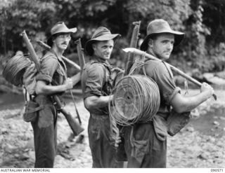 WONGINARA MISSION, NEW GUINEA. 1945-04-07. MEN OF 2/2 FIELD REGIMENT MOVING FORWARD WITH WIRE TO ARTILLERY SIGNAL COMMUNICATIONS DURING A PATROL WITH 2/3 INFANTRY BATTALION TROOPS IN THE TORRICELLI ..