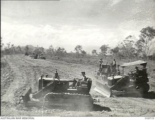 NADZAB, NEW GUINEA. C. 1944-02. BULLDOZERS OF NO. 62 MOBILE WORKS SQUADRON RAAF MAKING THE FIRST CUTS IN LIGHTLY TIMBERED KUNAI COUNTRY FOR A NEW AIRFIELD AT NADZAB