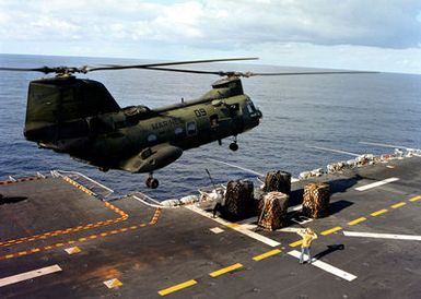 A CH-46E Sea Knight helicopter prepares to lift cargo from the flight deck of the amphibious assault USS GUAM (LPH-9) during flight operations off the coast of Beirut. The ship is providing support to U.S. Marines deployed in Lebanon as part of a multi-national peacekeeping force following confrontation between Israeli forces and the Palestine Liberation Organization