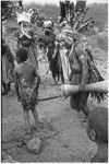 Pig festival, pig sacrifice, Tsembaga: ending the festival, fight magic men dispose of cordyline roots (previously buried at gate to dance ground) in direction of enemy territory