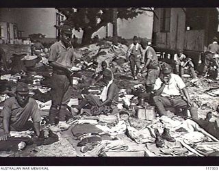 NAURU ISLAND. 1945-09-16. JAPANESE POWS AWAITING A KIT INSPECTION BEFORE BEING EVACUATED TO BOUGAINVILLE SOON AFTER TROOPS OF THE 31/51ST INFANTRY BATTALION TOOK OVER THE ISLAND