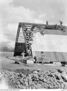 VIVIGANI, GOODENOUGH ISLAND, PAPUA NEW GUINEA. 1943-09-23. WORK IN PROGRESS ON THE ROOF DURING THE CONSTRUCTION OF AN "IGLOO" HANGAR BY MEMBERS OF NO. 7 MOBILE WORKS SQUADRON RAAF