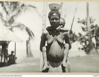 MANAM ISLAND, LNEW GUINEA. 1944-09-03. A NATIVE WOMAN OF THE SOGARI VILLAGE CARRYING HER SMALL SON IN THE APPROVED NATIVE FASHION