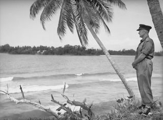 MILILAT, NEW GUINEA. 1944-08-09. WX3330 COLONEL A.L. DAWKINS, OBE, ASSISTANT DIRECTOR OF MEDICAL SERVICES, 5TH DIVISION, ADMIRING THE SCENERY FROM HIS TENT