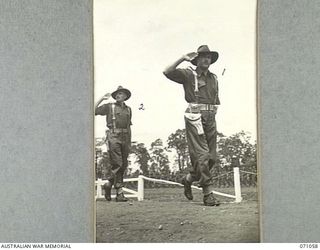 LAE, NEW GUINEA. 1944-03-08. NX94 LIEUTENANT COLONEL K.H. MONTGOMERY (1), COMMANDING OFFICER, 47TH INFANTRY BATTALION, SALUTING AS HE LEADS HIS UNIT PAST THE GENERAL OFFICER COMMANDING 2ND ..