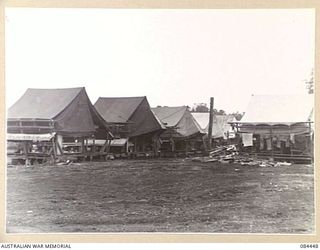 LAE, NEW GUINEA. 1944-12-21. THE MEN'S LINES AT THE UNTHANK MILL, SHORTLY AFTER THE CAMPSITE AREA HAD BEEN OPENED. THE CAMP SITE HAD BEEN SHIFTED BY 2/3 FORESTRY COY MEMBERS FROM ITS PREVIOUS SITE ..