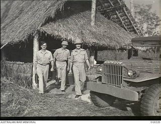 VIVIGANI, GOODENOUGH ISLAND, PAPUA. C. 1943-11. RAAF PUBLIC RELATIONS PARTY. LEFT TO RIGHT: PILOT OFFICER S. HUTCHINSON; CORPORAL B. GRAHAM; FLIGHT LIEUTENANT (FLT LT) J. WATERS, LEAVING THEIR ..