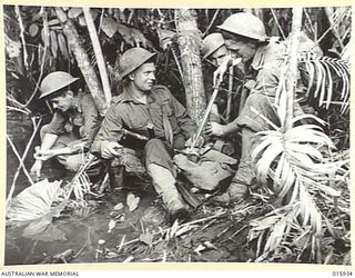 1943-10-06. NEW GUINEA. ATTACK ON LAE. THIS PLATOON OF A FAMOUS AUSTRALIAN BATTALION (PROBABLY THE 2/33 BATTALION) TOOK PART IN THE VICTORIOUS ADVANCE ON LAE. BESIDE A JUNGLE STREAM J. SHERRY OF ..