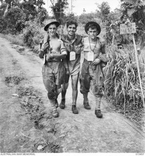 1942-12-16. PAPUA. SANANANDA TRACK. THREE WOUNDED AUSTRALIANS, ALL FROM NSW AND SERVING WITH 55/53RD BATTALION, MAKING THEIR WAY OUT OF THE FRONT LINE TO A FIRST AID STATION. LEFT TO RIGHT: N212796 ..