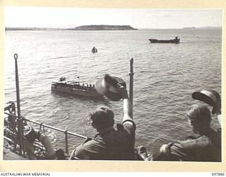 OFF BORAM BEACH, NEW GUINEA. 1945-10-13. THE FIRST BATCH OF TROOPS TO LEAVE THE WEWAK AREA UNDER THE PRIORITY DEMOBILISATION SCHEME WERE MEMBERS OF 6 DIVISION. A SURPRISE SEND OFF BY 2/5 INFANTRY ..