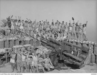 PORT MORESBY, PAPUA, 1942-07. AUSTRALIAN MILITIA ANTI-AIRCRAFT GUNNERS GROUPED AROUND ONE OF THEIR GUNS, WHICH HAS BEEN IN ACTION IN MANY RAIDS