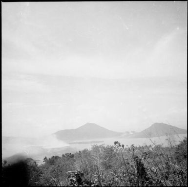 View of Vulcan Island after the volcanic eruption with Mother and South Daughter Mountains in the distance, Rabaul Harbour, New Guinea, 1937 / Sarah Chinnery