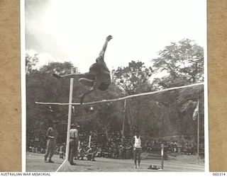 ELA BEACH, NEW GUINEA. 1943-11-13. CORPORAL E. E. HOFFMAN OF THE 394TH UNITED STATES PORT BATTALION COMPETING IN THE HIGH JUMP AT THE COMBINED SERVICES SPORTS