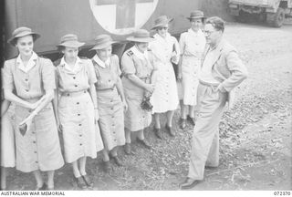 BISIATABU, NEW GUINEA. 1944-04-19. THE HONOURABLE E.J. WARD (1), MINISTER FOR EXTERNAL TERRITORIES IN THE AUSTRALIAN GOVERNMENT, WITH NURSES FROM THE 47TH CAMP HOSPITAL, AUSTRALIAN ARMY NURSING ..