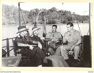 AT SEA, OFF SOUTH BOUGAINVILLE. 1945-09-09. MAJOR F.A. GODING (1) AND MAJOR F.C. TAYLOR (2), MEMBERS OF BUIN LIAISON GROUP, 2 CORPS, WITH LIEUTENANT G.C. PLATER, 13 LIGHT SHIPS COMPANY (3) AND ..