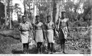 WEWAK, NEW GUINEA, 1945-08-15. FOUR NEW GUINEAN MEMBERS OF 'M' SPECIAL UNIT, ALLIED INTELLIGENCE BUREAU. FAR LEFT: MAMIN. FAR RIGHT: OPE