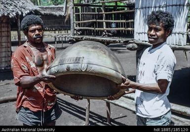 Amphlett pot, Linus Digim'Rina (right) and villager holding a large Amphlett clay pot