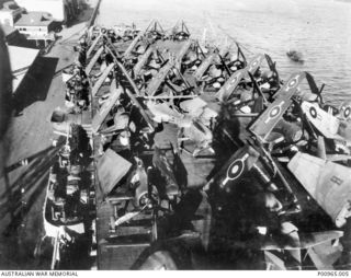 BRISBANE, QLD. C 1944. SUPERMARINE SEAFIRE II AIRCRAFT, WITH WINGS FOLDED, ON THE DECK OF BRITISH AIRCRAFT CARRIER HMS SLINGER. THE SLINGER IS IN BRISBANE RIVER PREPARING TO LEAVE FOR MANUS ISLAND. ..