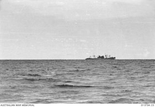 1942-12-08. NEW GUINEA. GONA. THE BATTERED HULK OUT TO SEA ABOUT A MILE FROM GONA BEACH IS A JAP SHIP SUNK BY THE ALLIED AIR FORCE SOMETIME AGO. IT IS BEING USED AS A STORE SHIP BY THE JAPS. ..