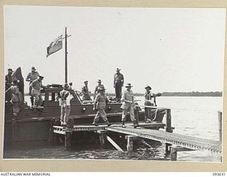 MOTUPENA POINT, BOUGAINVILLE, 1945-07-04. HIS ROYAL HIGHNESS, THE DUKE OF GLOUCESTER, GOVERNOR-GENERAL OF AUSTRALIA (1), COMING ASHORE AT THE JETTY FOR HIS VISIT TO HEADQUARTERS 3 DIVISION