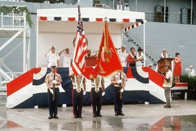 A US Marine Corps color guard participates in the welcoming ceremony for the combat stores ship USS NIAGARA FALLS (AFS 3) (AFS 3) (background)