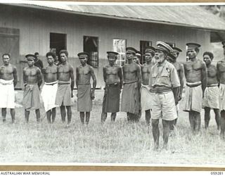 HOPOI, NEW GUINEA, 1943-10-30. CHIEFS OF THE VILLAGES IN THE AREA LISTENING TO AN ADDRESS BY NX155085 CAPTAIN R.G. ORMSBY OF THE AUSTRALIAN AND NEW GUINEA ADMINISTRATIVE UNIT. STANDING IN FRONT, TO ..