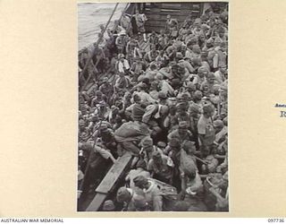 KAHILI, BOUGAINVILLE. 1945-10-02. JAPANESE ARMY TROOPS FROM THE BUIN AREA GOING ABOARD THE NEENA FROM AUSTRALIAN LANDING CRAFT. THEY ARE EN ROUTE TO THE CONCENTRATION AREA ON FAURO ISLAND