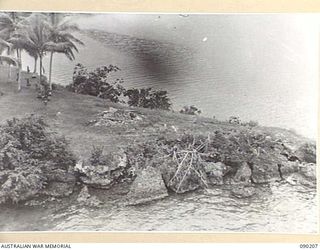 GOODENOUGH ISLAND, NEW GUINEA. 1942-10. IMITATION GUNS CLEVERLY CAMOUFLAGED, BY A SMALL GROUP OF AUSTRALIANS WHO SEIZED THE ISLAND. THEY ARE PART OF A MASTER PIECE OF BLUFF AND DECEPTION WHICH ..